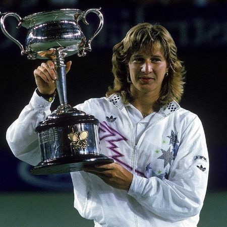 Jaz Elle Agassi's mother, Steffi Graf, holding up her trophy.